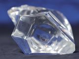 a clear glass object that is sitting on a black surface