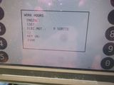 a picture of a pay phone with a work hours sign on the screen