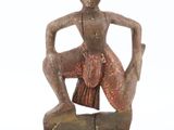 an image of a statue of a woman sitting on top of a wooden block