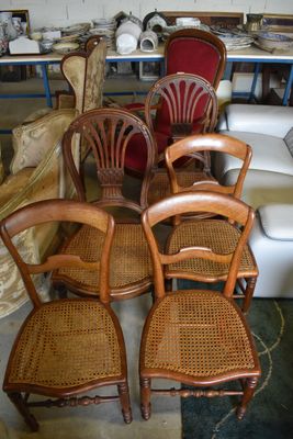 four chairs that are sitting next to each other in a room