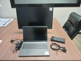 a laptop computer sitting on top of a wooden desk