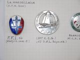 several different badges are shown on a piece of paper