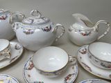 many different types of tea and saucers on the table