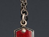 an image of a red and silver tag with the letter a on it