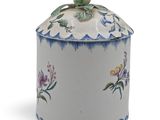 a white container with blue and pink flowers on it