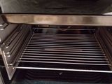 an open oven with the door open and a pan in it