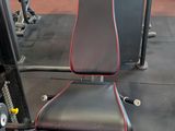 an image of a gym room with a bench and weights
