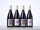 three bottles of wine are lined up on a table