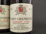 two bottles of wine sitting next to each other on a table