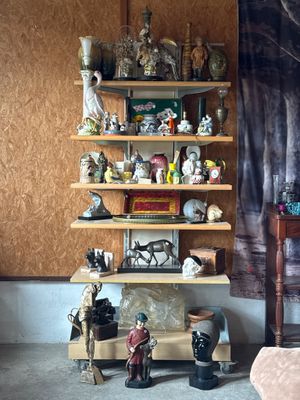 a shelf that has a lot of figurines on it