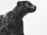 a statue of a dog that is standing on a pedestal