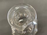 a clear glass jar with a piece of ice inside of it