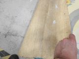 a person that is holding a piece of wood in their hand