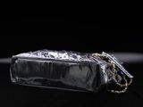 a close up of a black purse on a black surface
