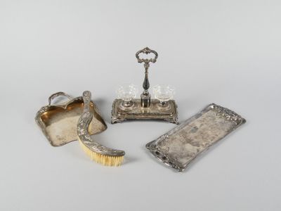 three pieces of silverware including a brush, a tray and a bottle