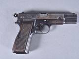 an old gun is laying on a table with a white background