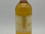 bottle of white wine sitting on a white surface with a white background