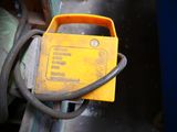 a close up of a yellow device attached to a machine