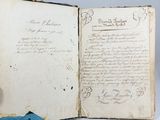 an open book with writing on it sitting on top of a table
