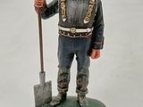 a figurine of a man with a shovel in his hand