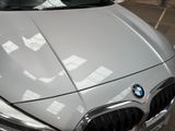 a car that is parked in a parking lot with a sticker on the hood