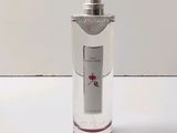a bottle of perfume sitting on a white surface
