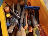 a yellow box filled with tools and a pair of scissors
