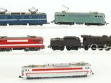 four different colored trains on a white surface