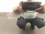 a man kneeling down holding a cell phone in his hands