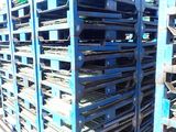 many pallets stacked on top of each other in the dirt