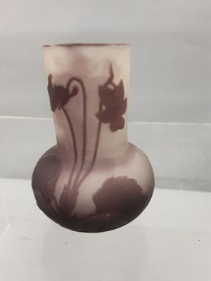 a glass vase that has a flower design on it