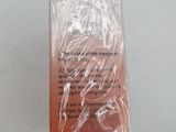 packaging of a bottle of liquid sitting on top of a white table