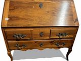 a small wooden desk with a drawer on top of it