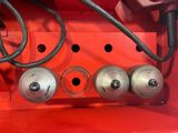 an image of a red machine with a bunch of metal balls