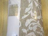 a brown and white blanket on a wooden table