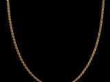 a gold chain necklace on a black background