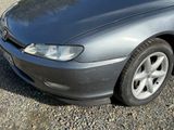 a picture of a car parked in a gravel lot