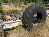 a tire that is sitting in the grass next to a fence
