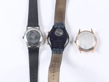 three different watches sitting next to each other on a white surface