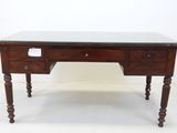a wooden desk with a glass top and wooden legs