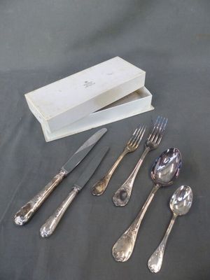 five forks, a knife, a spoon, and a box on a table