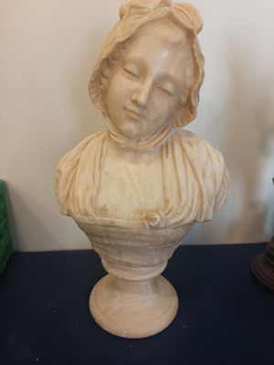a statue of a woman that is sitting on a table