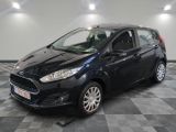 a black ford fiesta parked on a checkered floor in a garage