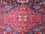 an oriental rug with a red, blue, and yellow design