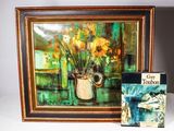 une photo représentant un tableau et un livre posés sur une table