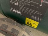 a close up of a green container with a sticker on it