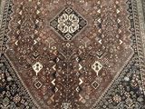 a close up of a brown and black rug on a wooden floor