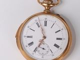 a gold pocket watch with roman numerals on it