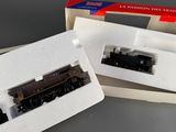 two model trains sitting in a box on a table