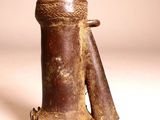 an old wooden object with a wooden handle on a white surface